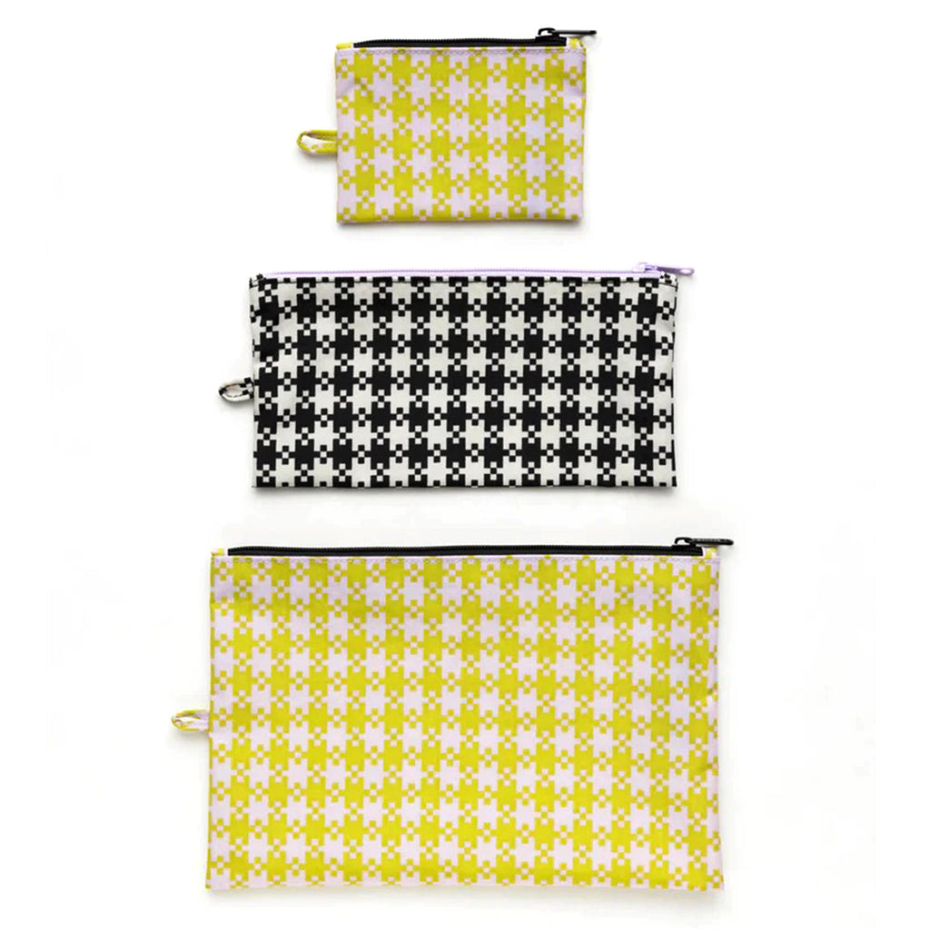 Baggu Flat Zipper Pouch set of 3, all with a pixel gingham print, the small and large in pistachio green and lilac and the medium size in black and white.