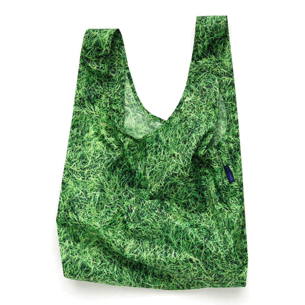 Baggu standard size eco-friendly-recycled ripstop nylon reusable tote bag with green grass pattern, unfolded.