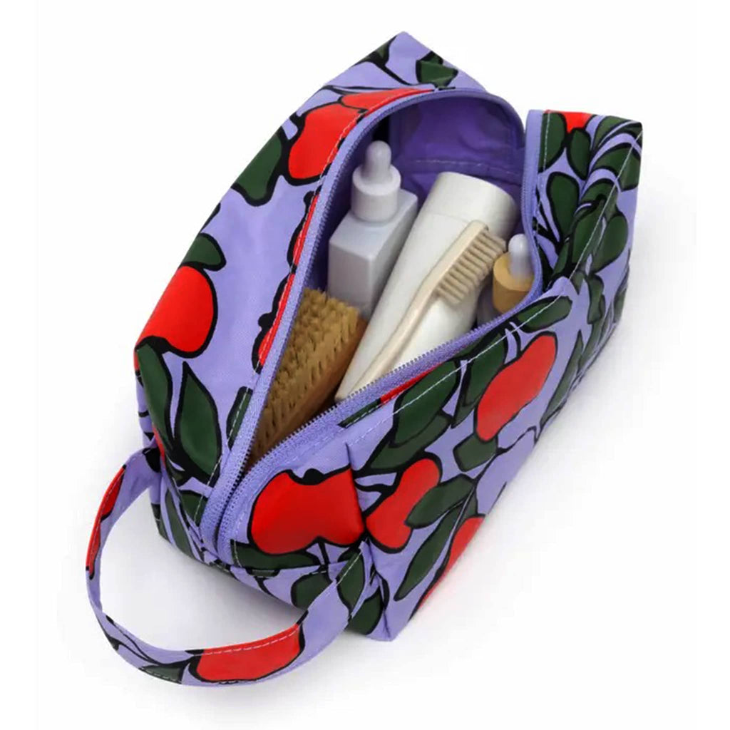 Baggu Apple Tree Dopp Kit, overhead view, open with toiletries inside.