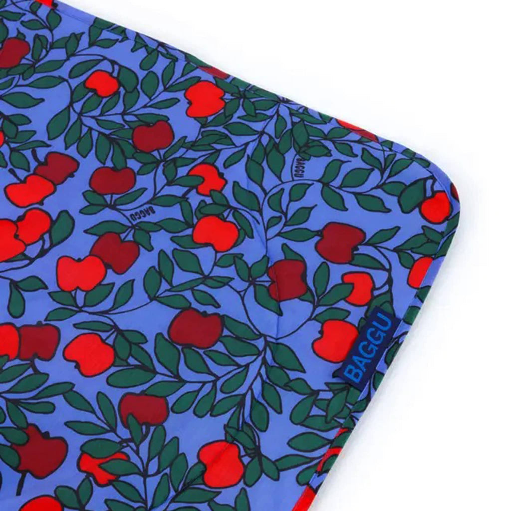 Baggu Apple Tree puffy recycled ripstop nylon and polyester picnic blanket, detail of corner.