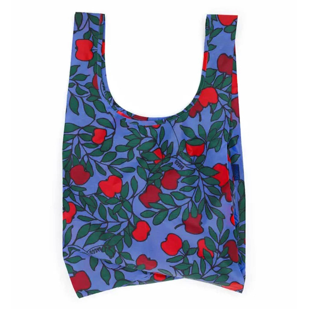 Reusable bag with red apple pattern on a blue background.