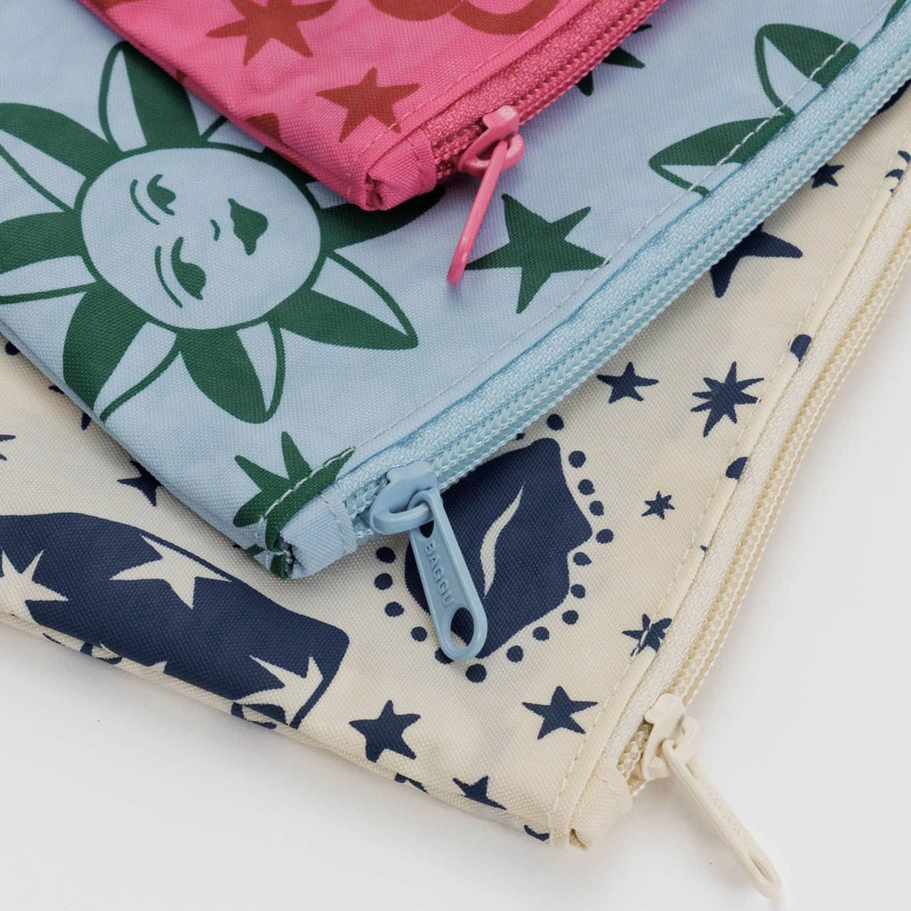 Baggu recycled ripstop nylon flat zipper pouches, set of 3 in assorted sizes with prints from the Charm collection, detail of corner and zip pull.