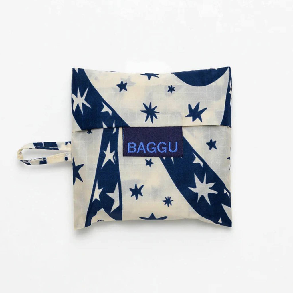 Baggu baby size eco-friendly-recycled ripstop nylon reusable tote bag with a blue Cherub Bows pattern on a white backdrop, in matching pouch.