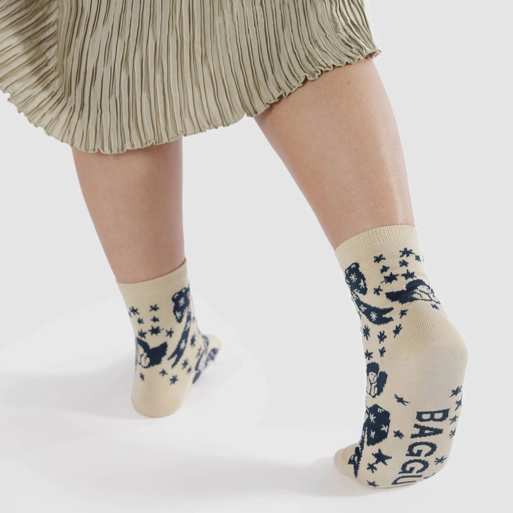 Baggu bamboo rayon unisex crew socks with blue and white Cherub Bows print, being worn on model.