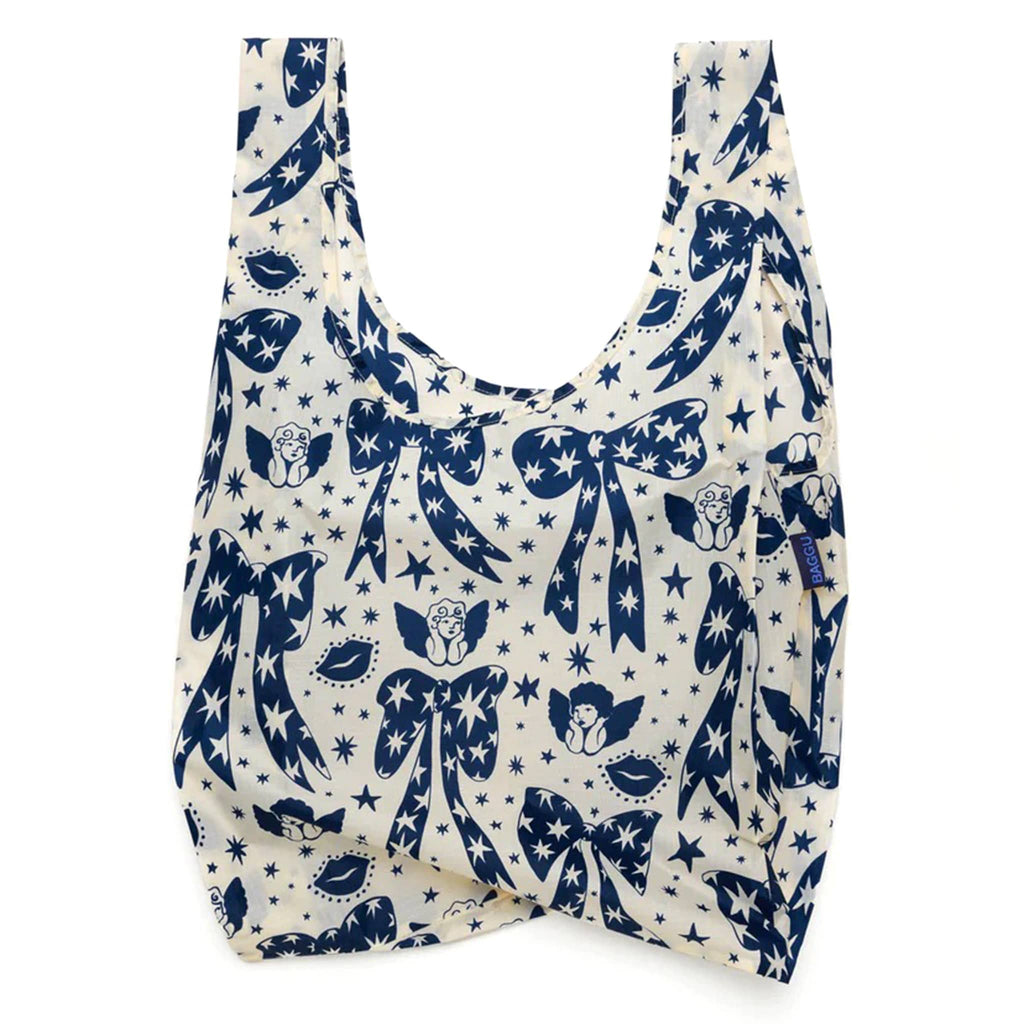 Baggu standard size eco-friendly recycled ripstop nylon reusable tote bag with blue and white Cherub Bows print, unfolded.