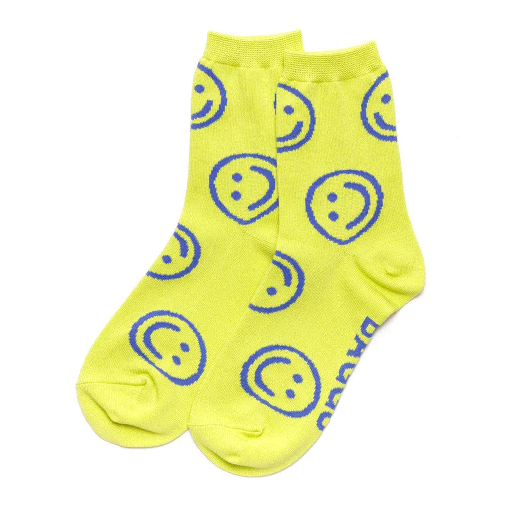 Baggu bamboo rayon unisex crew socks with blue smiley faces on a citron background, flat.