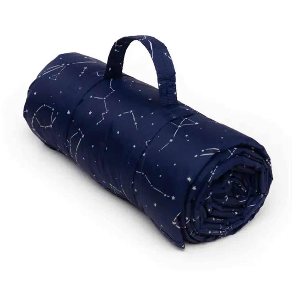 Baggu Puffy Picnic Blanket in Constellation Midnight print, rolled up.