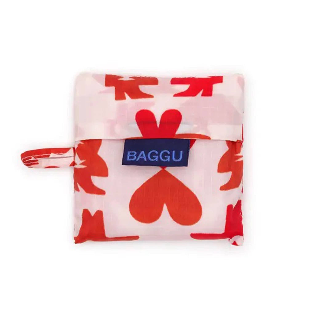 Folded reusable bag with red Cowgirl  pattern in matching pouch with 'BAGGU' logo on a white background.