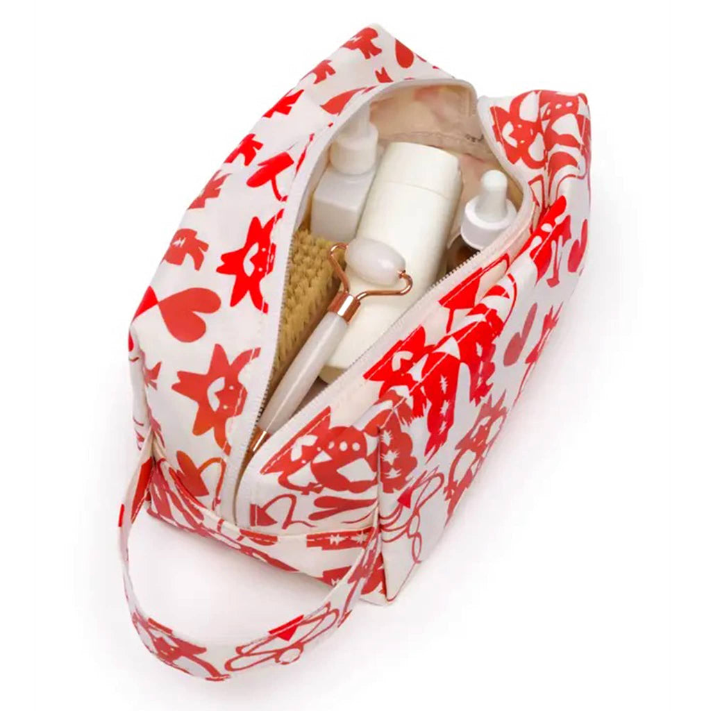 Baggu Cowgirl Dopp Kit, overhead view, open with toiletries inside.