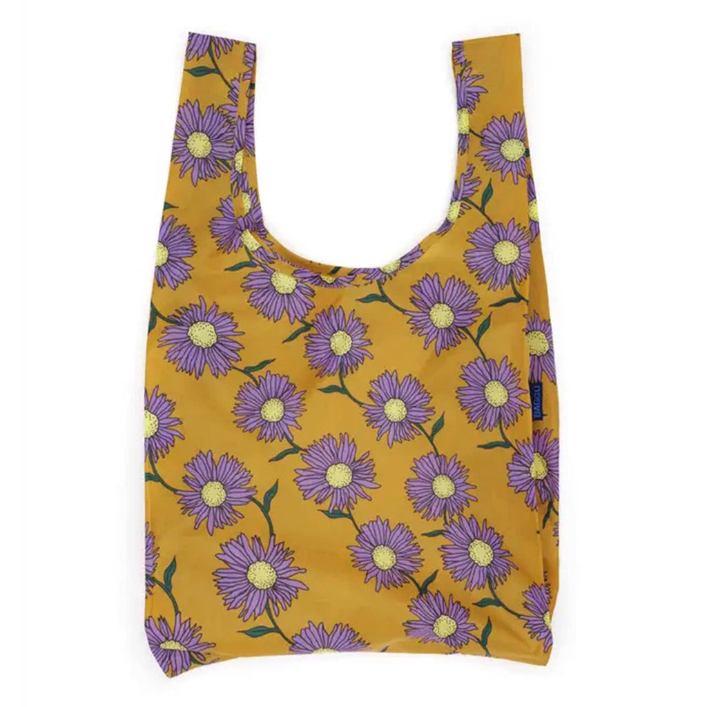Reusable shopping bag with purple flower pattern on mustard yellow background.