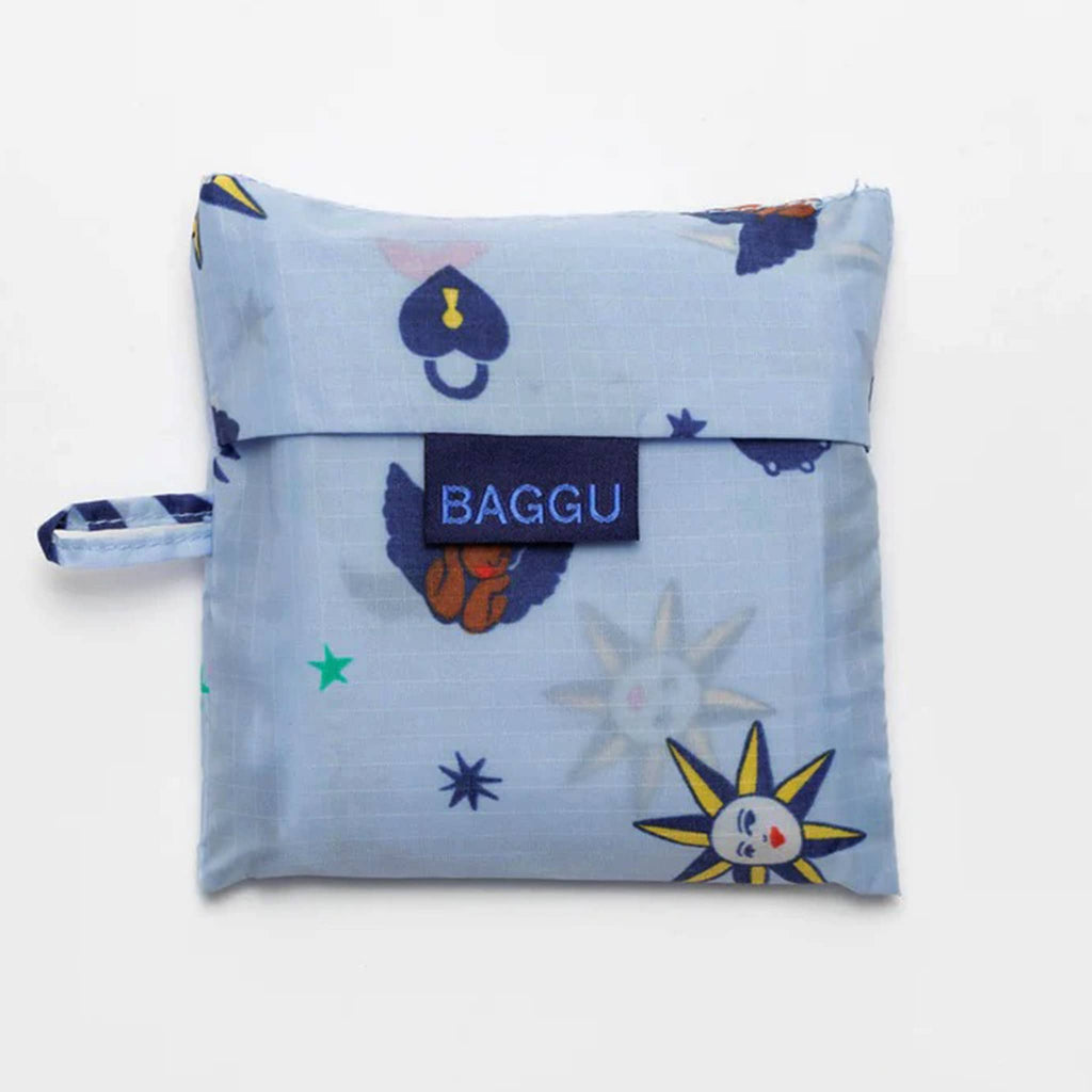 Baggu standard size eco-friendly recycled ripstop nylon reusable tote bag with Ditsy Charms print on a light blue backdrop, in matching pouch.