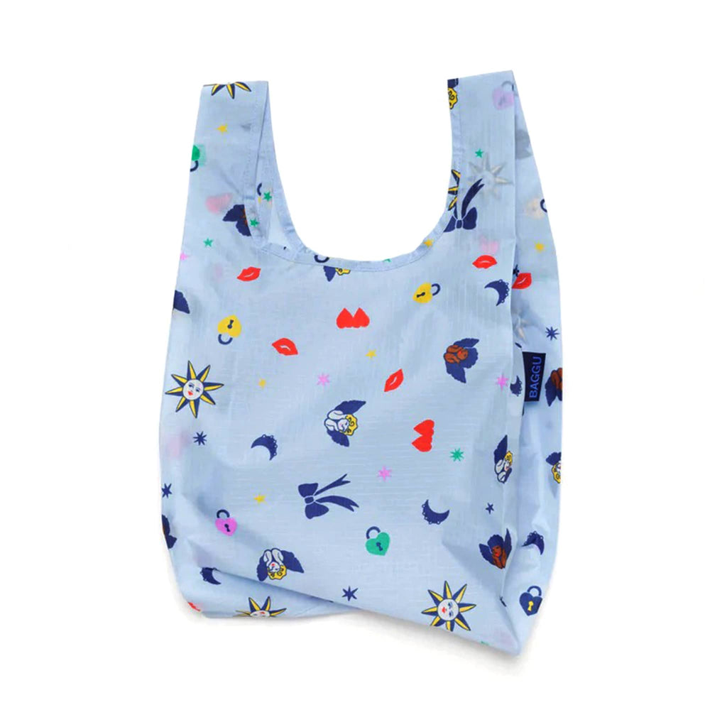 Baggu baby size eco-friendly recycled ripstop nylon reusable tote bag with Ditsy Charms print on a light blue background, unfolded.