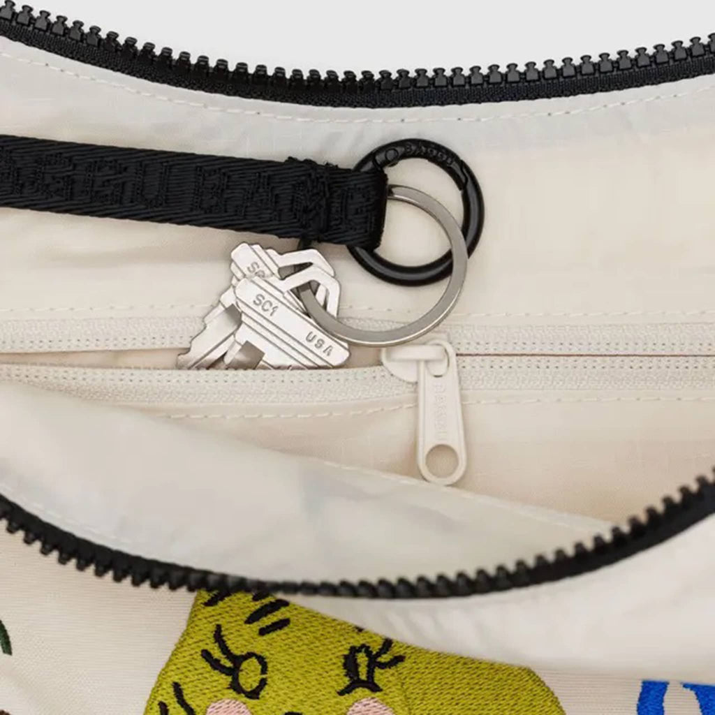 Baggu Embroidered Painted Prairie medium ripstop nylon crescent bag, detail of key ring and interior zip pocket.