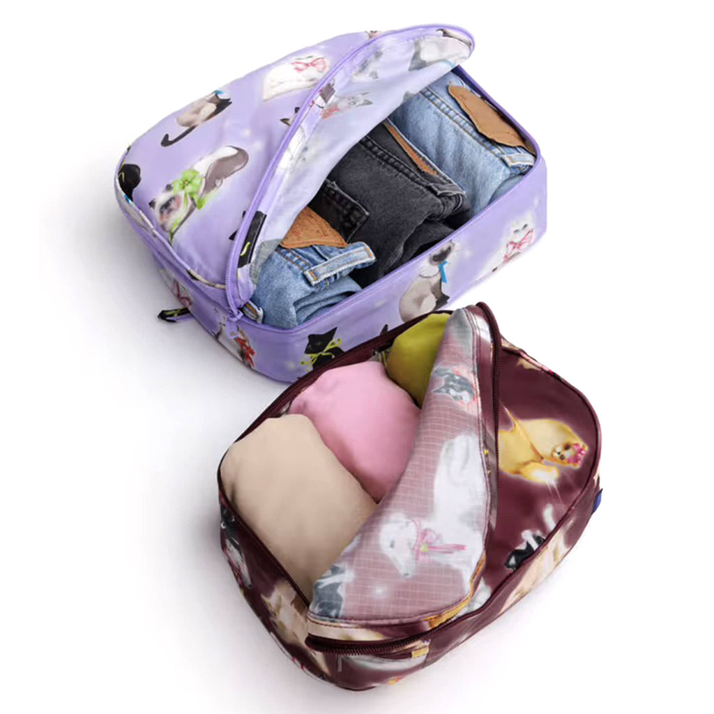 Baggu Fancy Animals reusable recycled polyester packing cubes, set of two, unzipped and stuffed with clothing, on a white background.