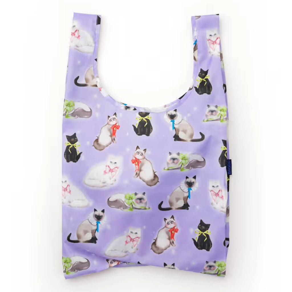 Purple reusable shopping bag with cat pattern on a white background.