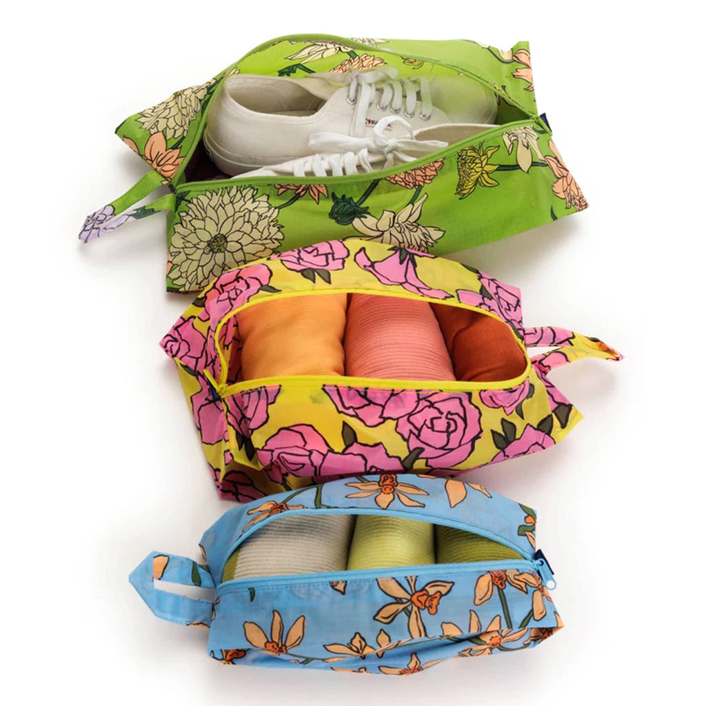 Baggu reusable recycled ripstop nylon 3D zip bags, set of 3 in Garden Flowers prints, unzipped and filled with shoes and clothing.