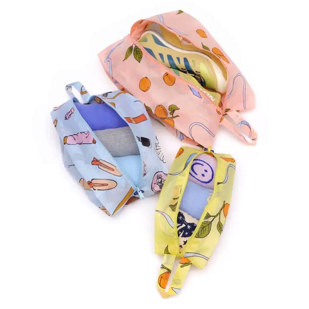 Baggu 3D zip set trio in Get Ready With Me collection prints, open with socks, tees and shoes inside.