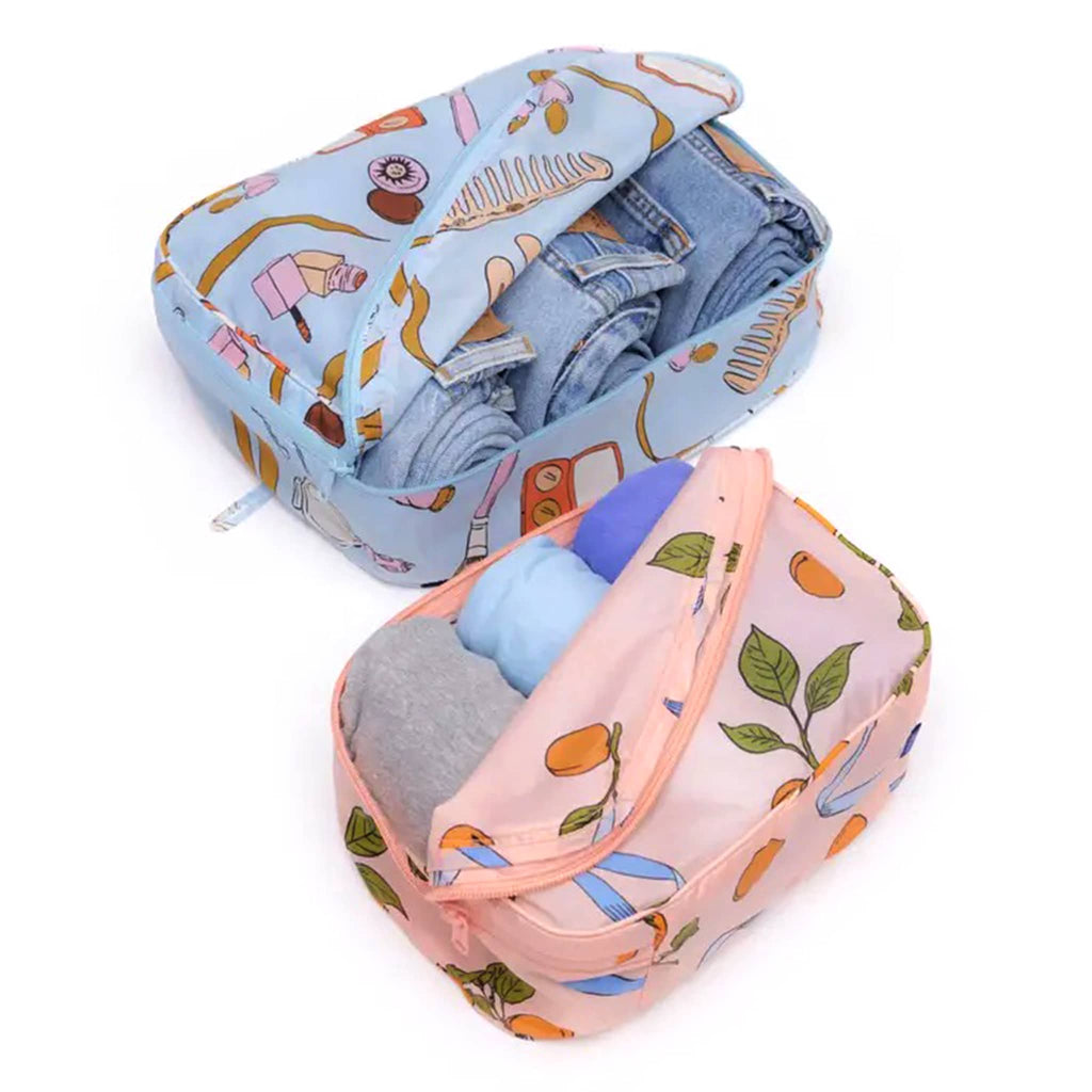 Baggu Packing Cube Set of 2 in Get Ready With Me collection prints, open and filled with jeans and tees.