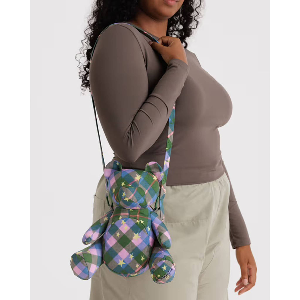 Person wearing a bear bag with colorful plaid design on a white background.