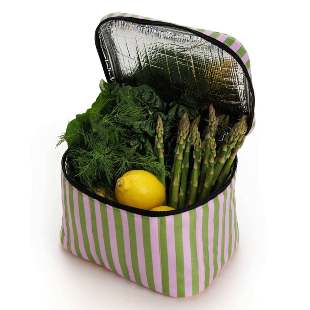 Baggu Insulated Puffy Lunch Bag with pink, green, yellow and blue stripes with black zipper and handle, front angle view, lid open showing spinach, dill, lemons and asparagus inside.