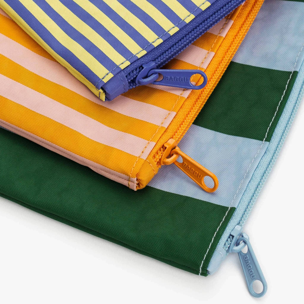 Baggu recycled ripstop nylon flat zipper pouches, set of 3 in assorted sizes with prints from the Hotel Stripes collection, detail of corner and zip pull.