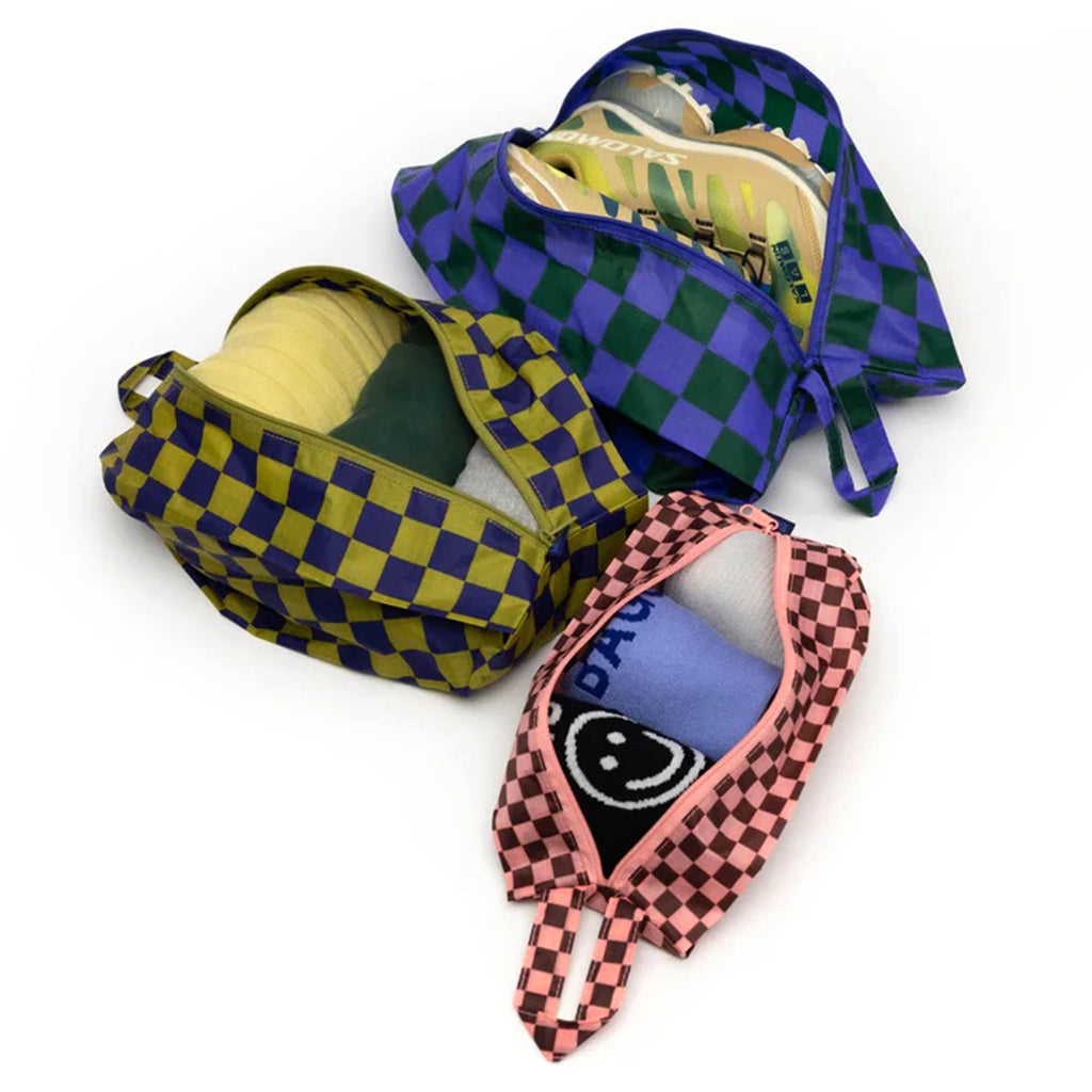 Baggu reusable recycled ripstop nylon 3D zip bags, set of 3 in Jewel Check prints, open and filled with sneakers, socks and garments.