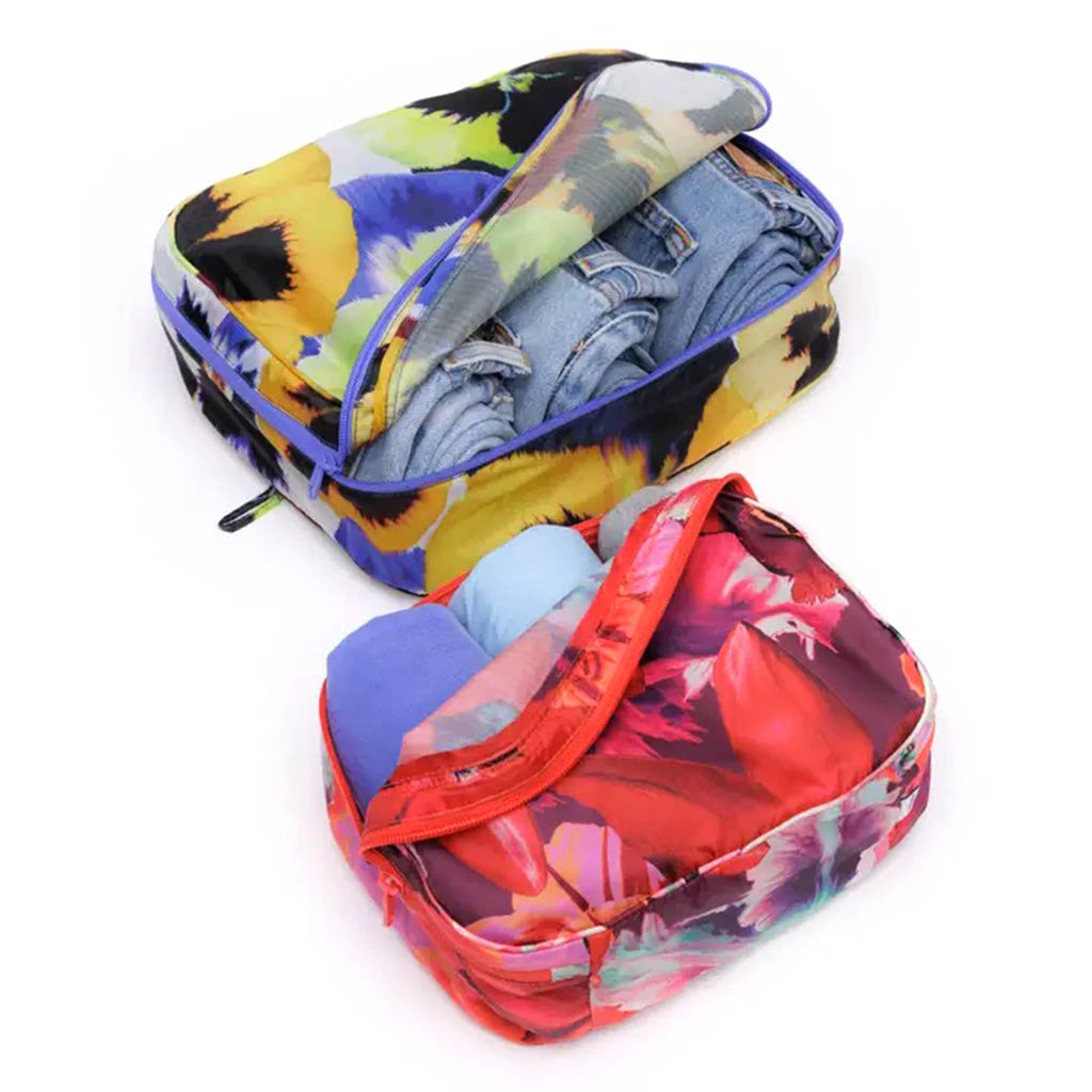 Baggu Packing Cube Set of 2 in Julia Heuer collection floral prints, open with jeans and tees inside.