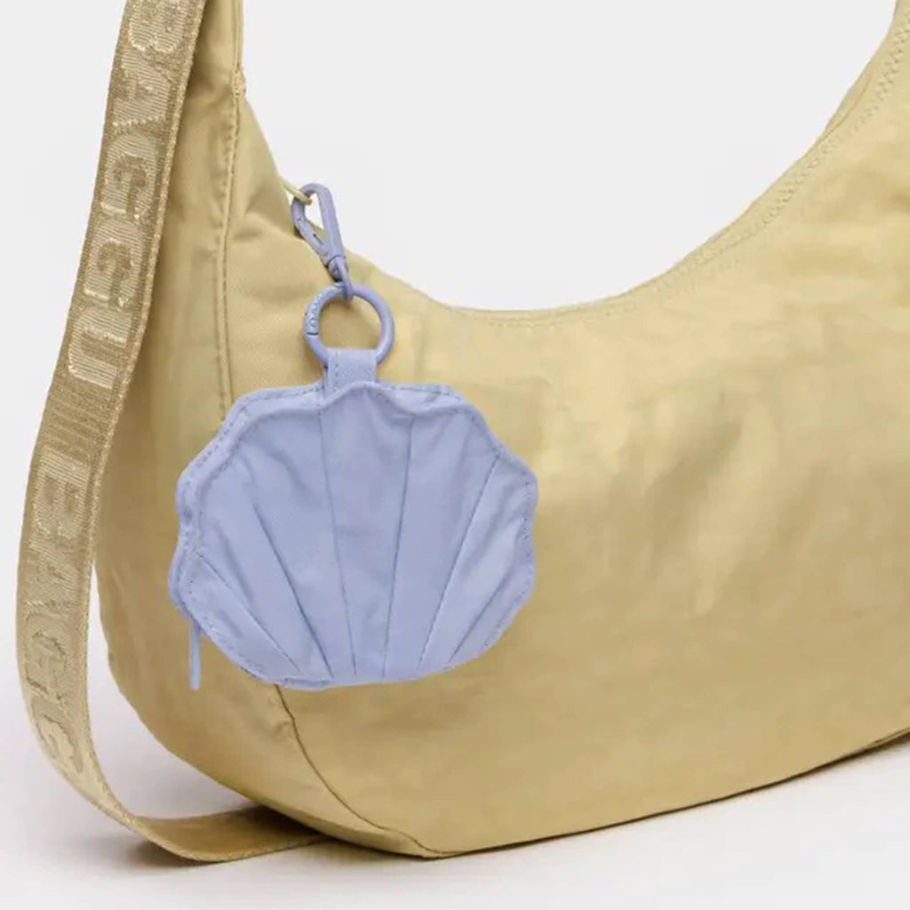 Baggu Lavender Grey recycled nylon shell-shaped zip charm, clipped on a crescent bag.