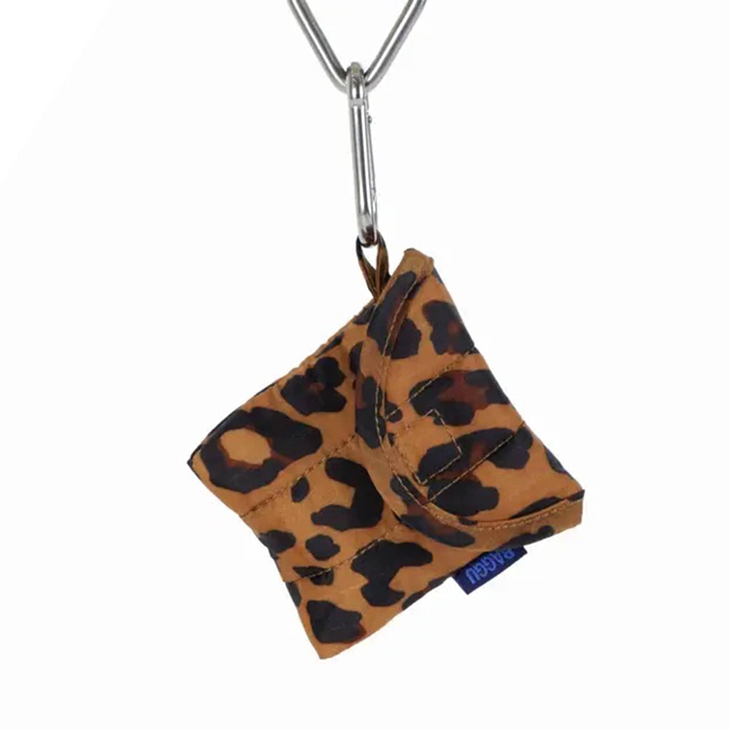 Baggu puffy earbuds case with leopard  print, hanging from a metal carabiner.