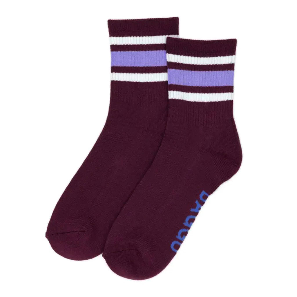 Pair of maroon socks with white and purple stripes on a white background.