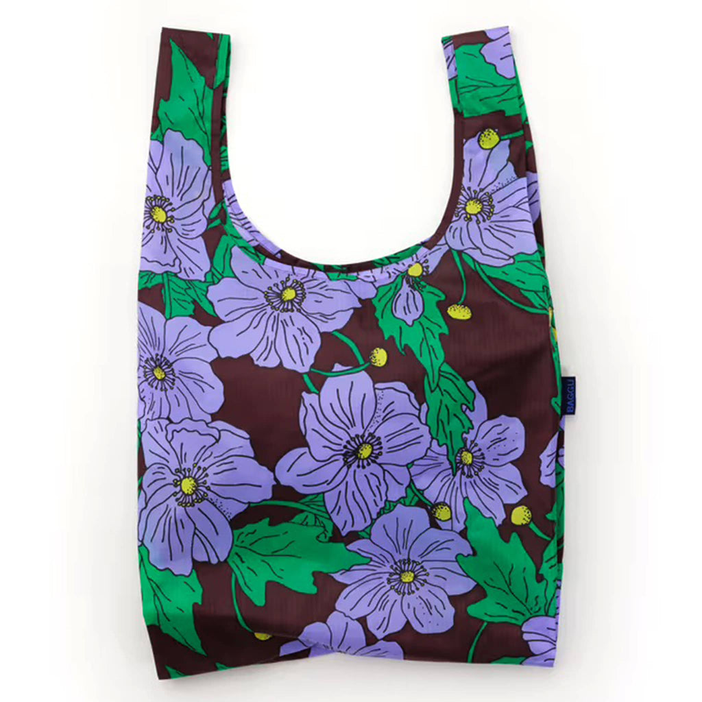 Reusable shopping bag with purple floral design on mahogany backdrop, on a white background.