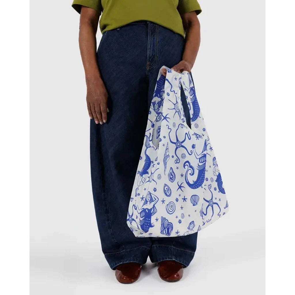 Baggu Mermaid standard ripstop nylon reusable bag, in models hand.