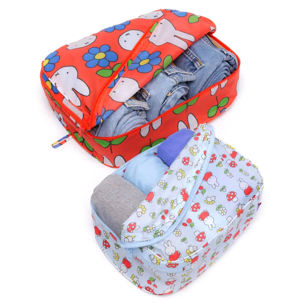 Baggu Packing Cube Set of 2 in Miffy collection prints, zipped open with jeans and t-shirts rolled up inside.