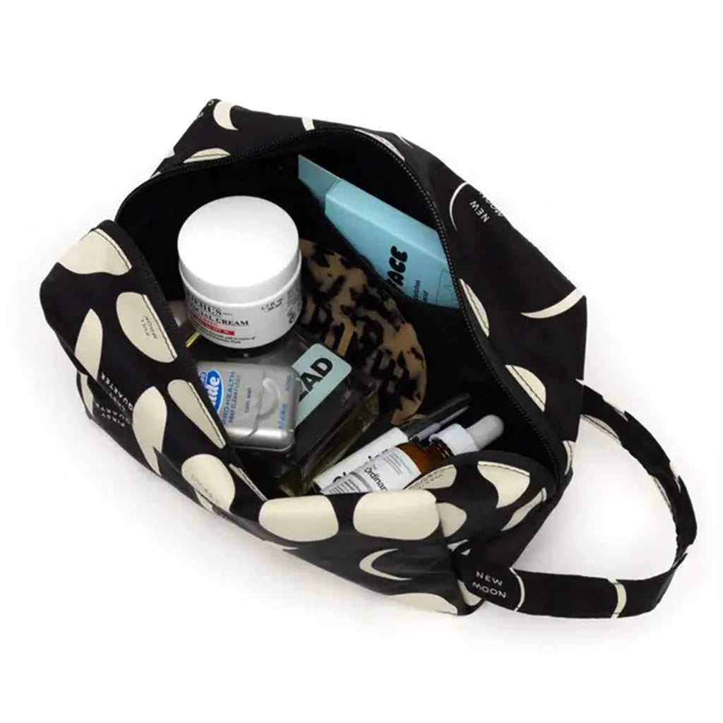 Baggu Dopp Kit in Moon print, open with toiletries inside.