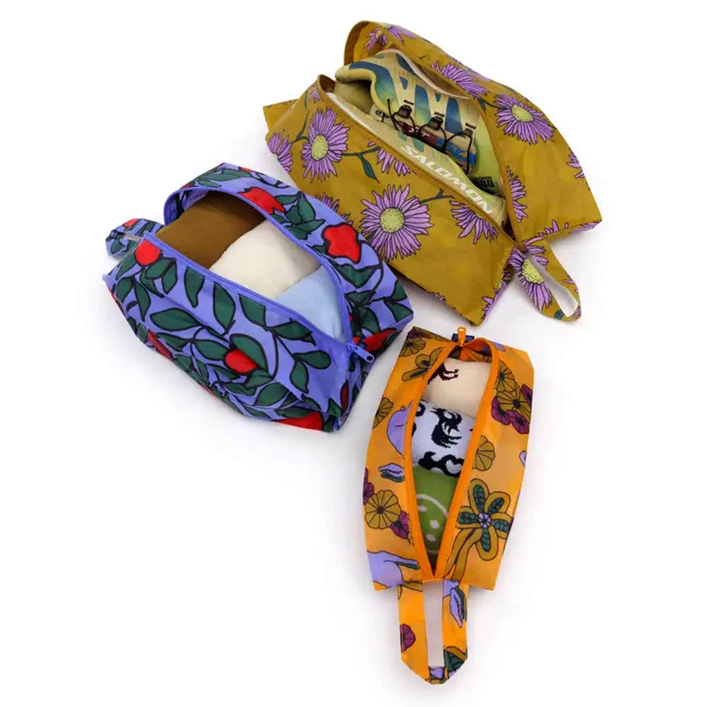 Baggu Night Orchard reusable recycled nylon 3d zip set bags, set of 3 in different prints, overhead view, stuffed with clothes and open.
