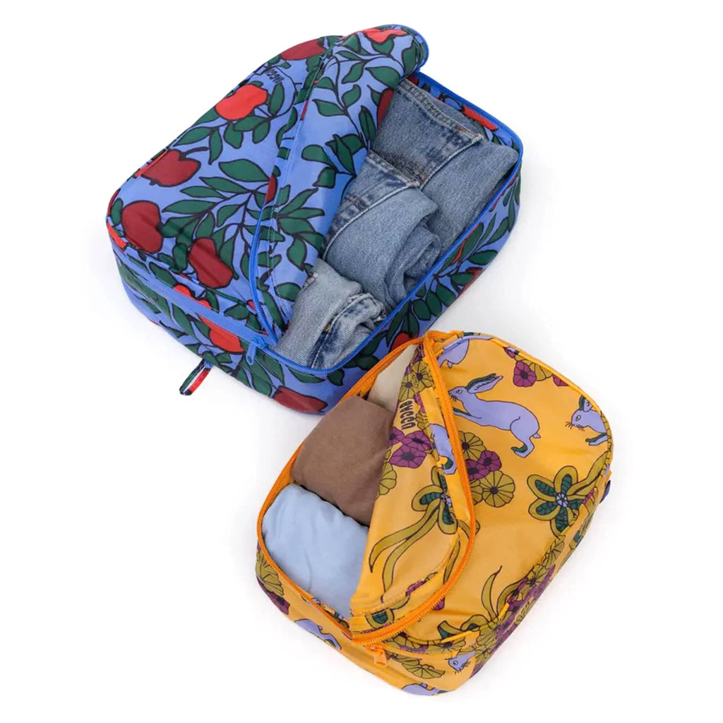 Baggu Night Orchard reusable recycled nylon packing cubes, set of two, open and filled with clothes.