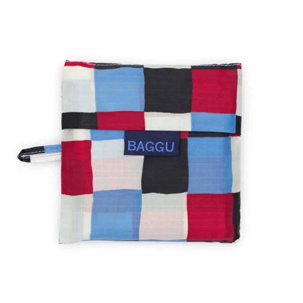 Colorful checkered tote bag in matching pouch with 'BAGGU' branding on a white background.