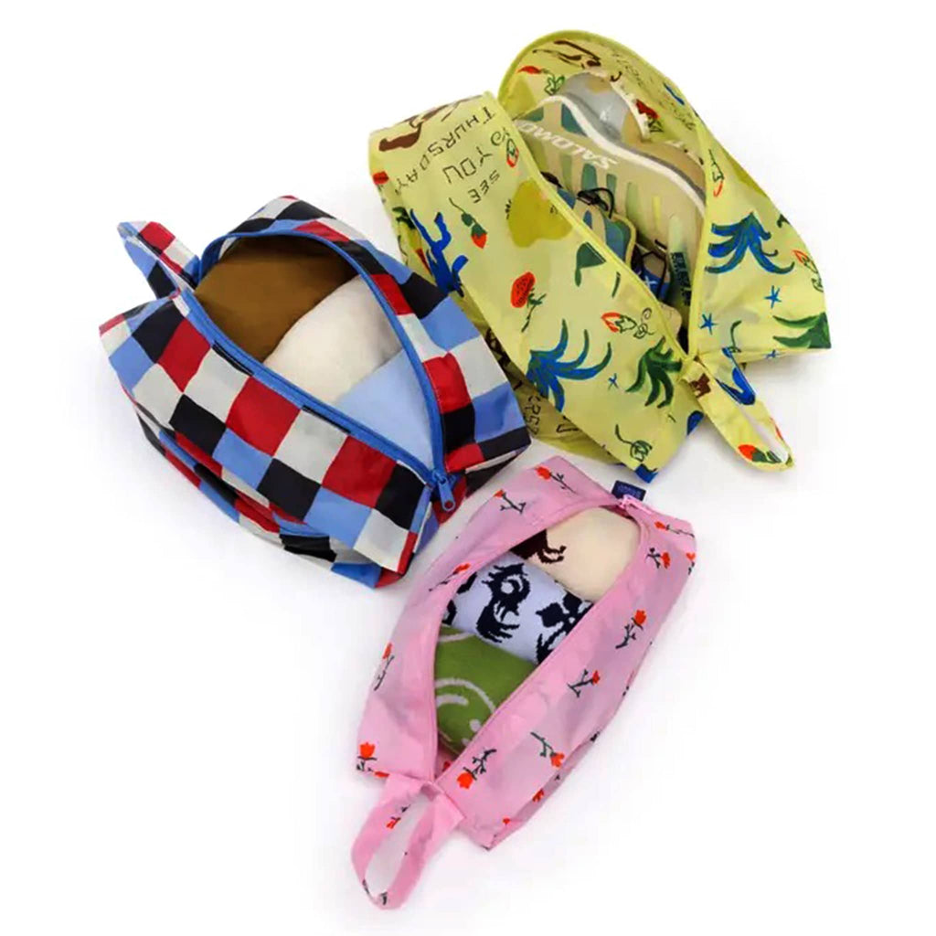 Baggu Painted Prairie reusable recycled nylon 3d zip set bags, set of 3 in different prints, overhead view, stuffed with clothes and open.