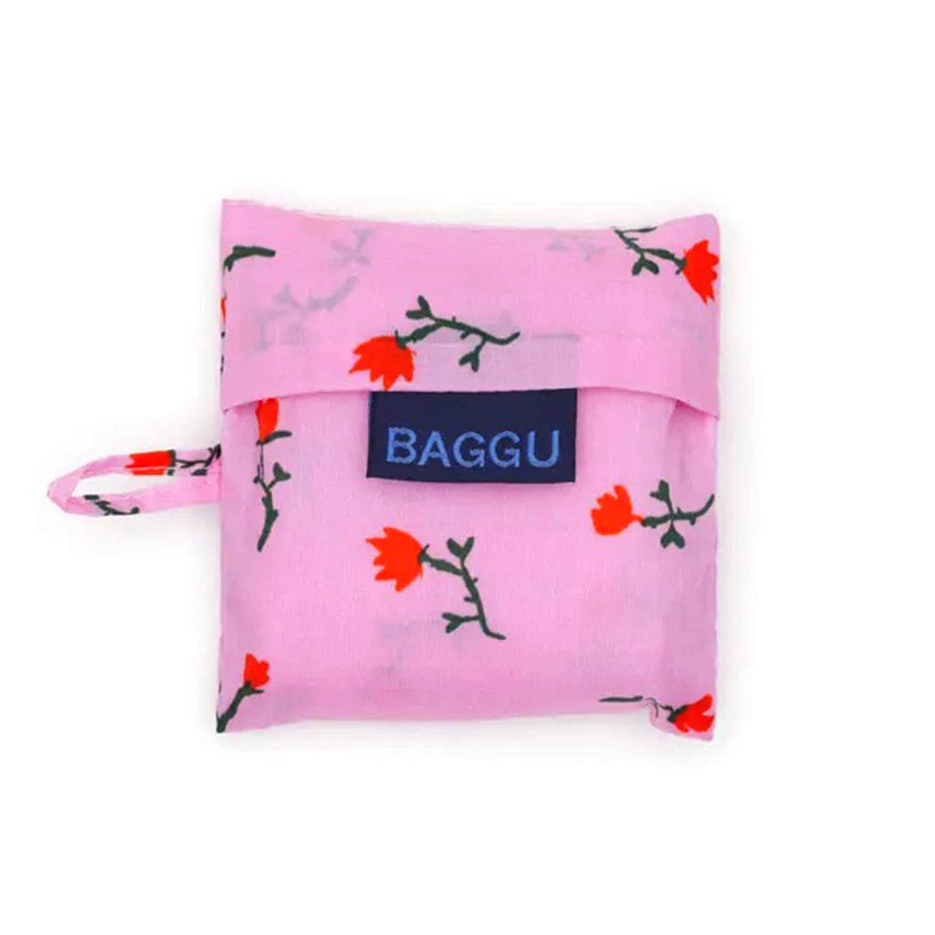 Pink floral-patterned bag in matching pouch with 'BAGGU' logo on a white background.