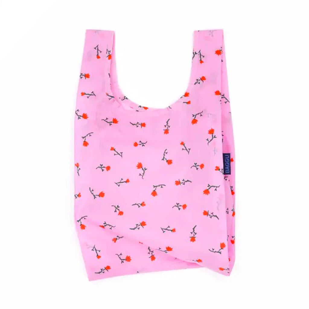 Pink reusable bag with floral pattern on a white background.