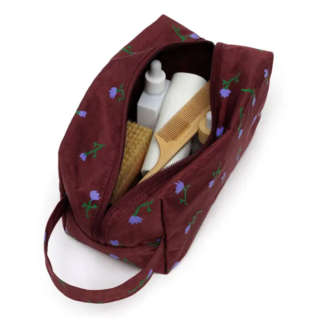Baggu Painted Wildflower Dopp Kit, overhead view, open with toiletries inside.