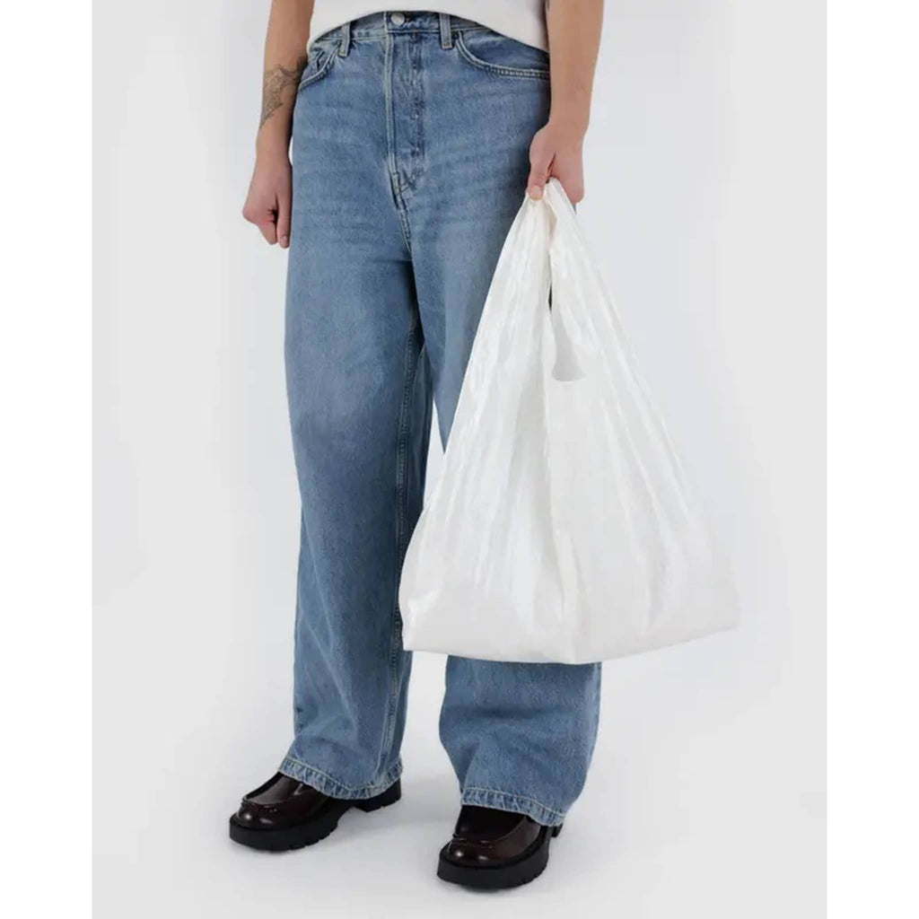 Baggu Pearl Metallic standard ripstop nylon reusable bag, in models hand.