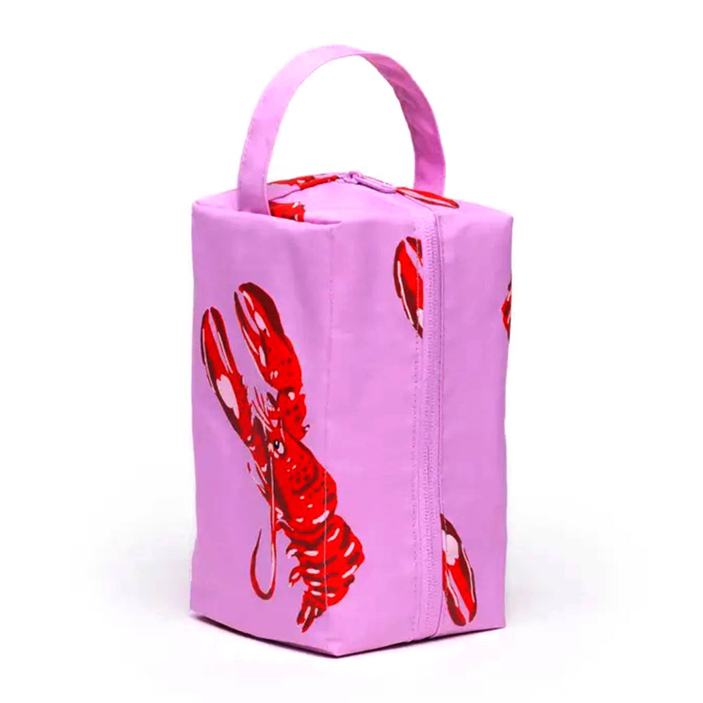 Baggu Pink Lobster Dopp Kit, standing upright with handle.