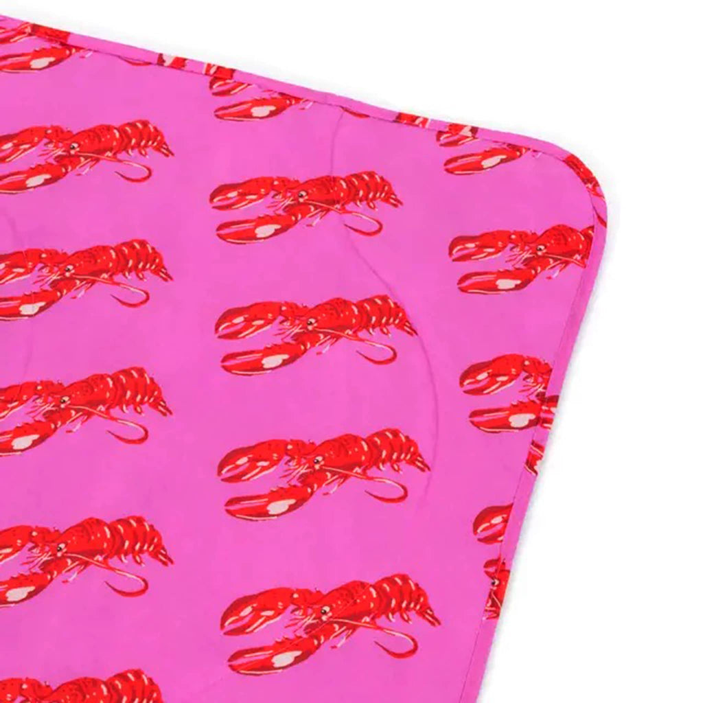 Baggu Pink Lobster puffy recycled ripstop nylon and polyester picnic blanket, corner detail.