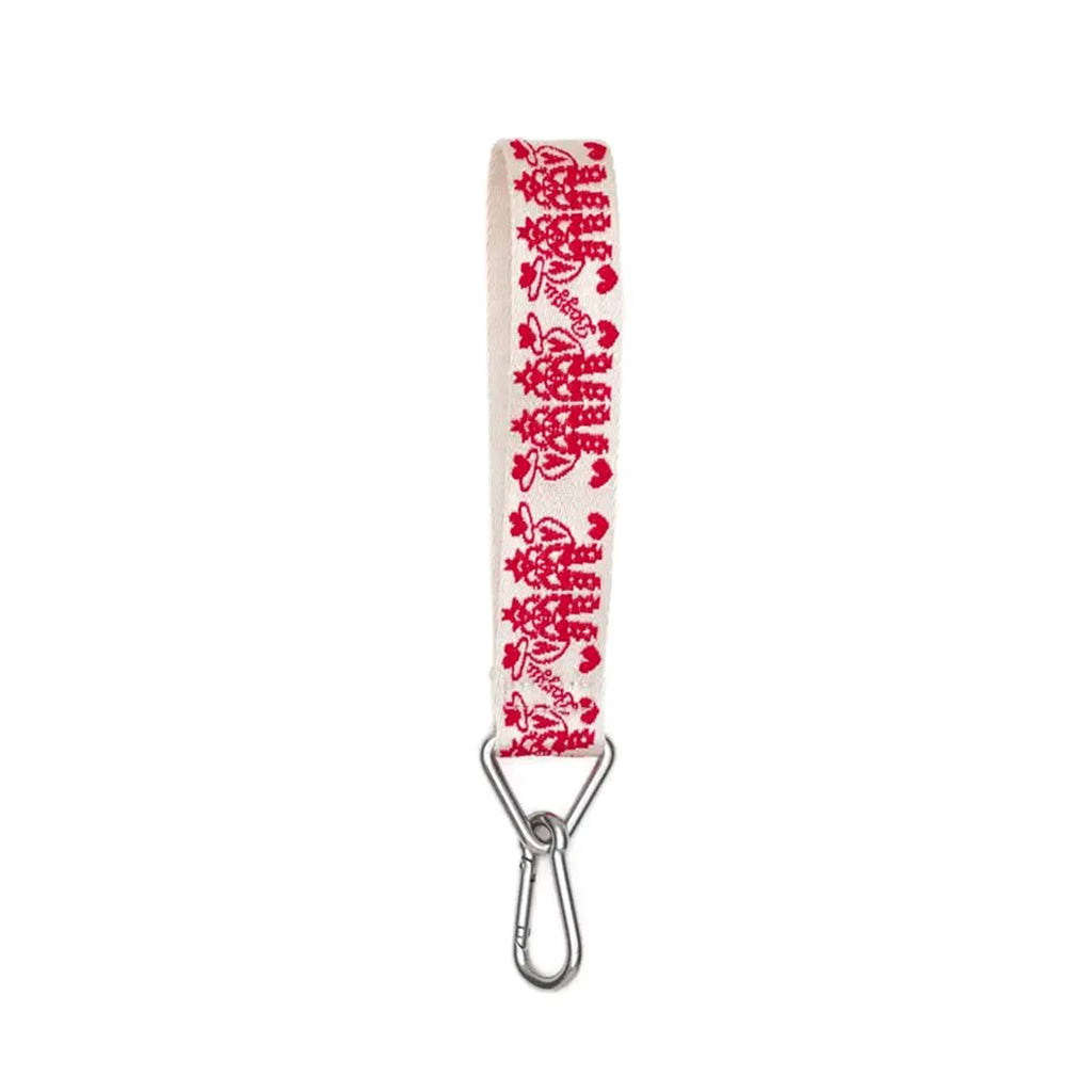 A white webbed nylon keychain with the Cowgirl print in red with Baggu logo, featuring a metal clip and a triangle ring.