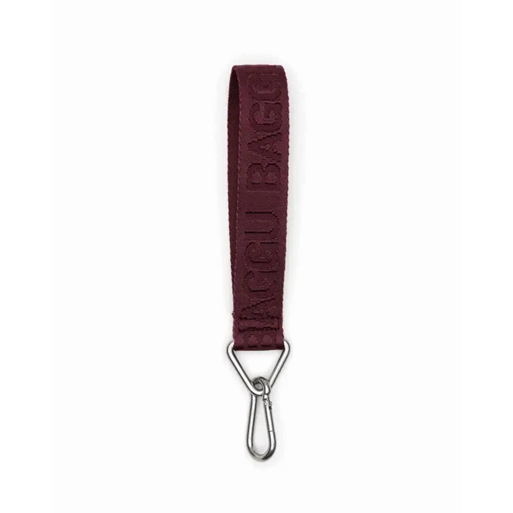 A burgundy webbed nylon keychain with the Baggu logo, featuring a metal clip and a triangle ring.