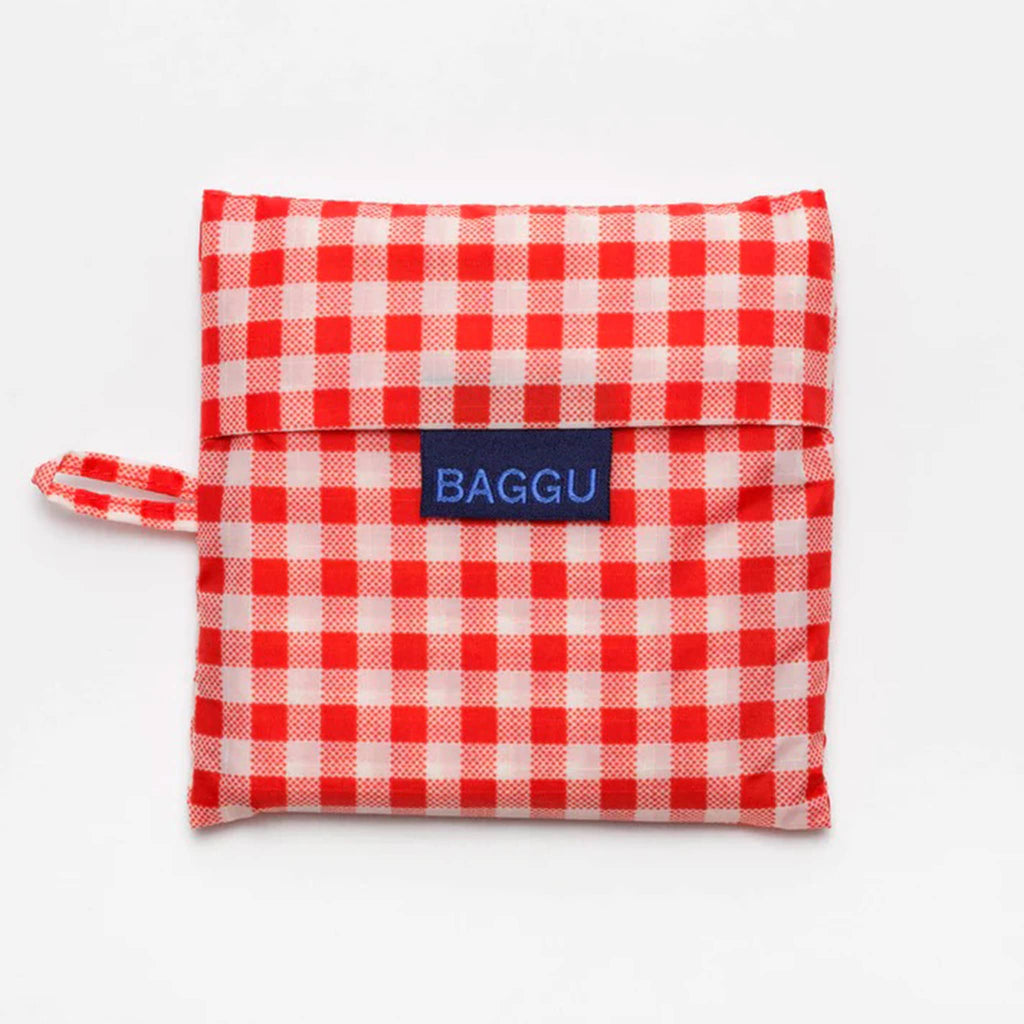 Baggu standard size eco-friendly recycled ripstop nylon reusable tote bag with red and white gingham print, in matching pouch.