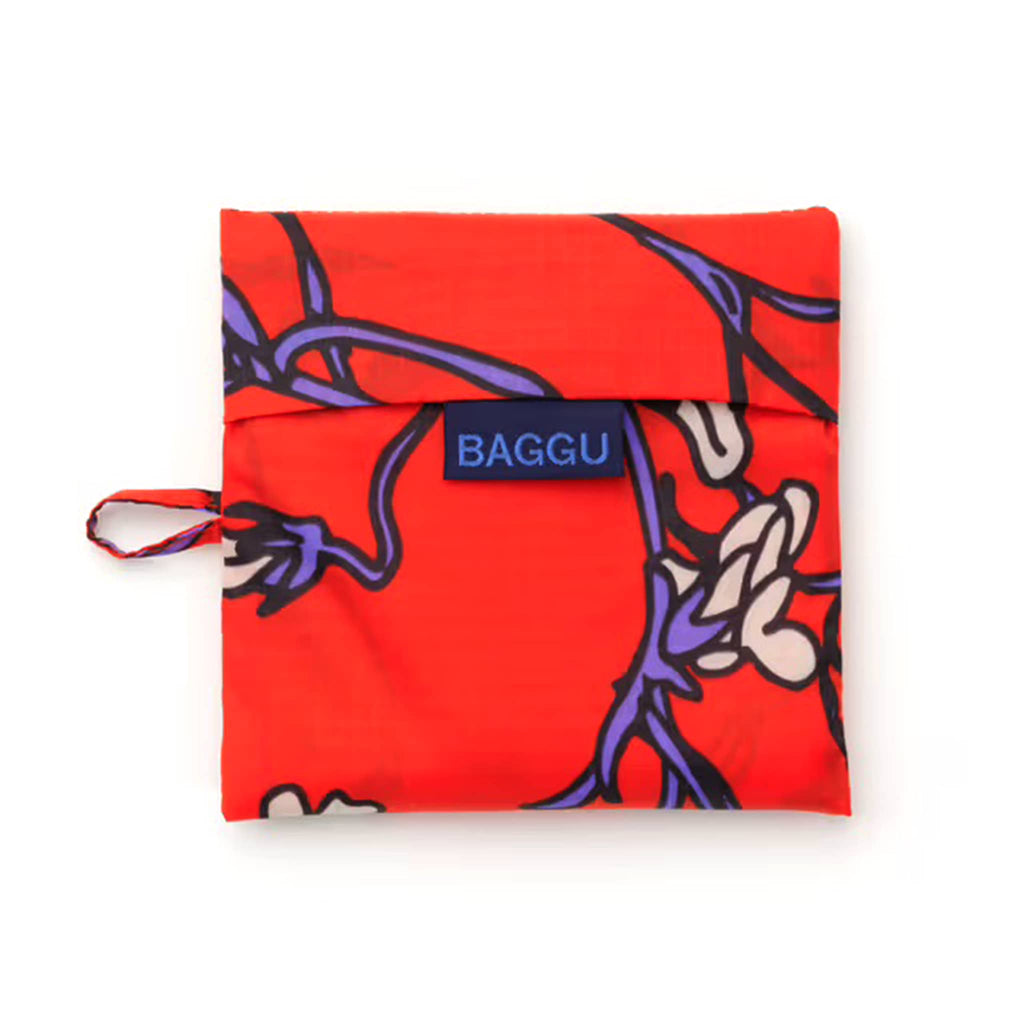 Red reusable bag in matching pouch with floral pattern and 'BAGGU' branding on a white background.