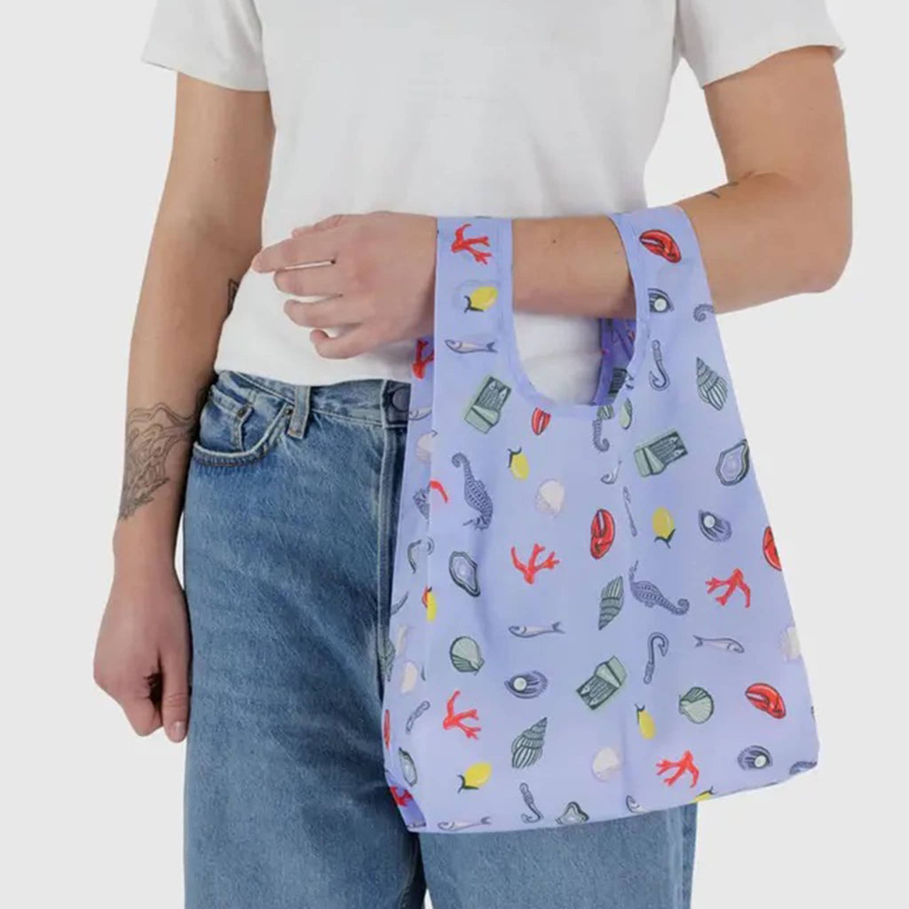 Baby Baggu Sea Charms ripstop nylon reusable bag, on models arm.
