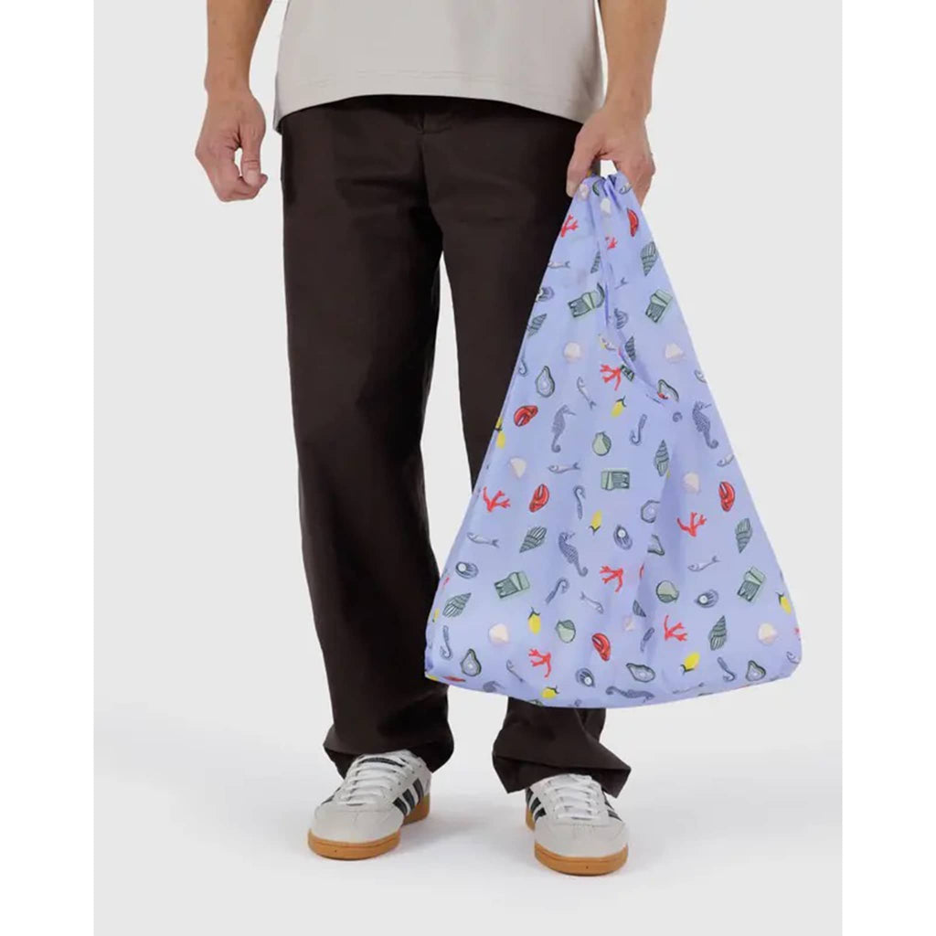 Baggu Sea Charms standard ripstop nylon reusable bag, in models hand.